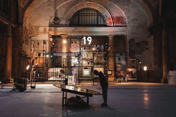 Man looking at exhibit in industrial train station.